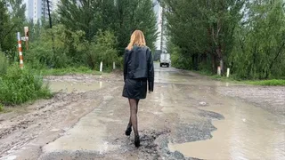 Girl in stockings and high heeled shoes walking in mud and crush her stockings