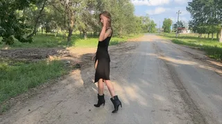 girl in high heeled boots walking in the mud