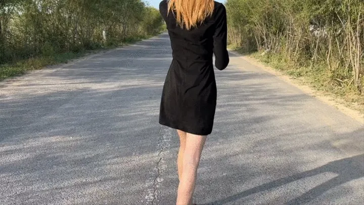 girl in high-heeled sandals stuck her shoes to the road and a passer-by decided to make fun of her shoes and feet and began to crush them