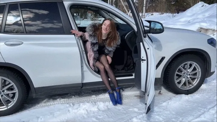 girl in extremely high heels walks on ice in ballet boots