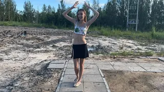 girl bathes in mud, staining her stomach and the rest of her body with mud