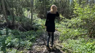 a beautiful girl is lost in the forest and is trying to get out on the road in high heeled boots, but there is a mountain of mud on her way, which she cannot climb in any way