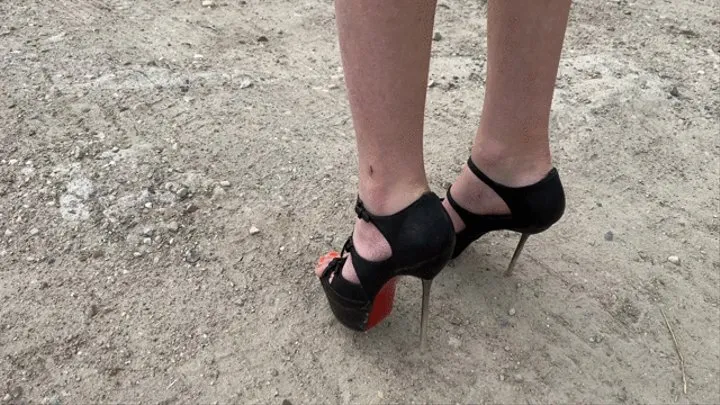 a girl in high heels pierces plastic, wood, bottles and other objects with her sharp heels