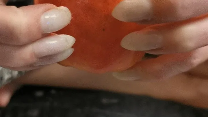 Pointy natural nails clawing apple