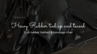 Heavy Rubber Helmet - tied up and teased on bondage chair
