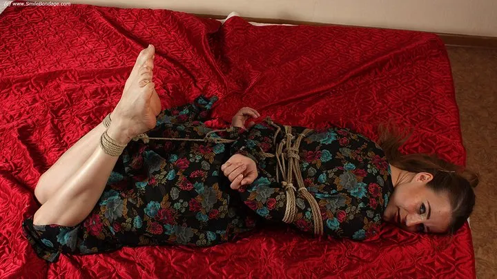 Anne: barefoot girl in flower dress, hogtied on the floor with hemp rope, wiggles and poses