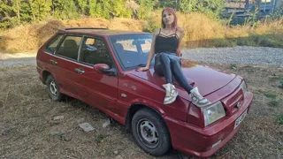 Redheaded babe gives maximum revs on a rusty Lada