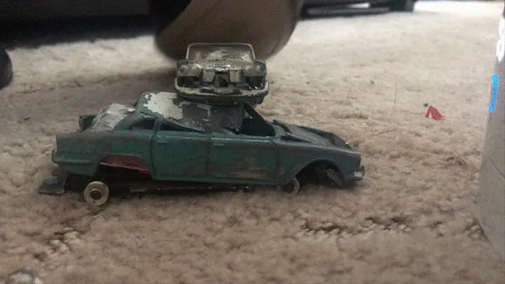 Metal toy car crush with heels close up