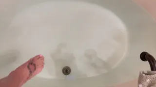 Carissa wearing the sparkly sheer bodysuit in the bathtub and wielding her glass dildo!