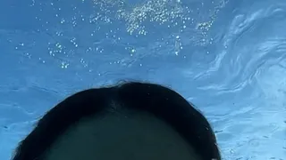 Slow motion swim in public pool in vintage 1 piece
