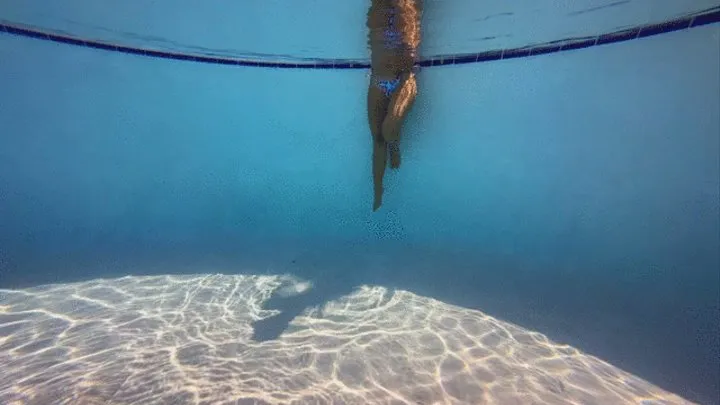 Bikini and mermaid tail in the public pool at the resort