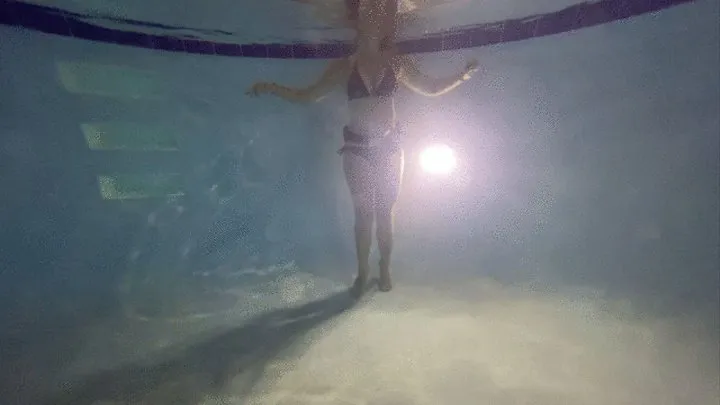 Underwater partial nudity in a public pool with old school weight belt and oval mask