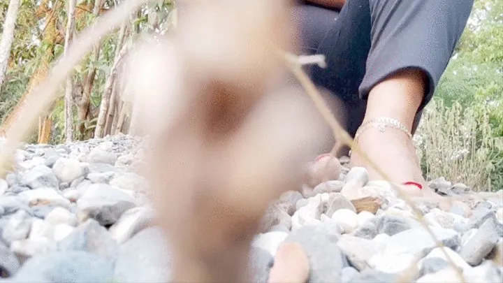 Diana Senior playing with marblestones under her barefeet