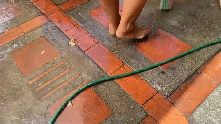 Balbina sweeping and cleaning the backyard barefoot