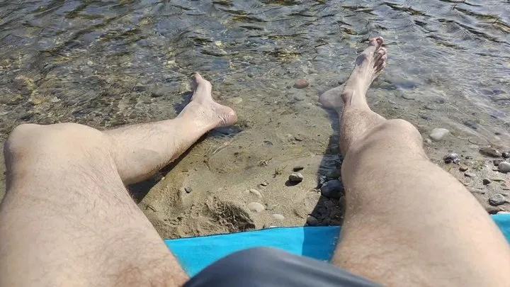 Sunbathing on the river bench, dipping my feet in the water