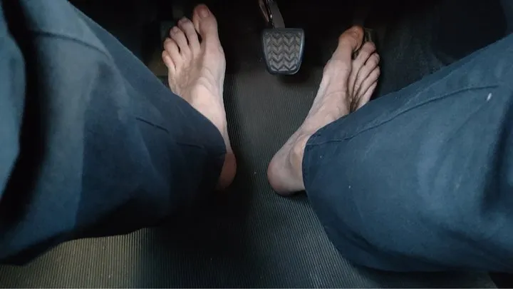 Riding a car, pedal pumping barefoot - soles above the hard pedals