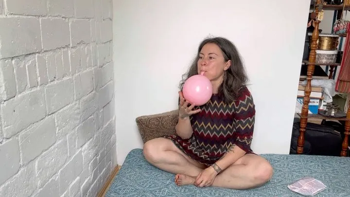 blowing three balloons