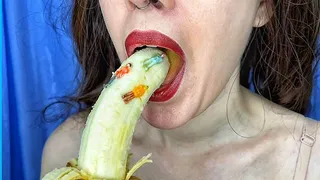 The giantess is sucking a banana on which tiny people