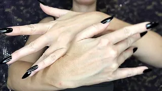 Graceful hands with long black nails will captivate your gaze