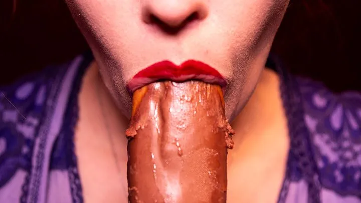 Girl passionately sucks a chocolate eclair