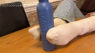 Playing with a water bottle using just my feet in dirty white socks