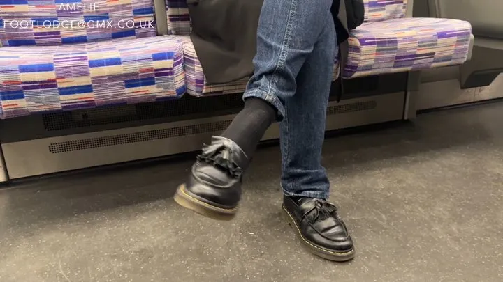 Candid shoeplay on the London Underground Train