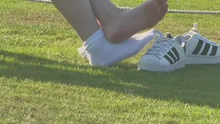 Candid shoeplay in sneakers and socks in public