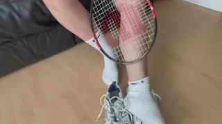 Amelie removes her Nike socks and sneakers after her tennis lesson