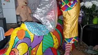 clown girl on infatable rhino play with balloons