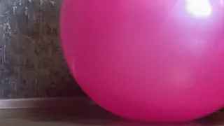 girl in jeans deflate pink gym ball