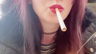 Bee smoking with red lipstick outside