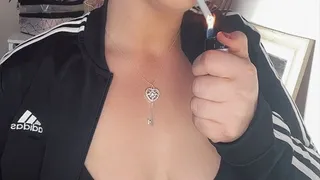 Smoking in my adidas jacket, gold hoop earrings showing off my natural tits