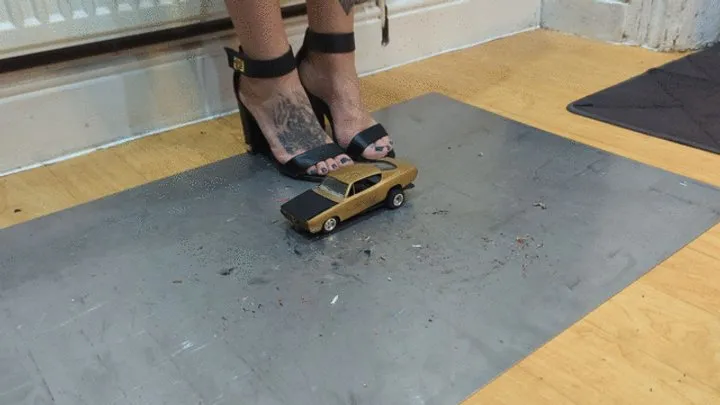 Giantess Atari queen destroys a Plymouth Barracud toy car crush in sexy black heels closeup left view