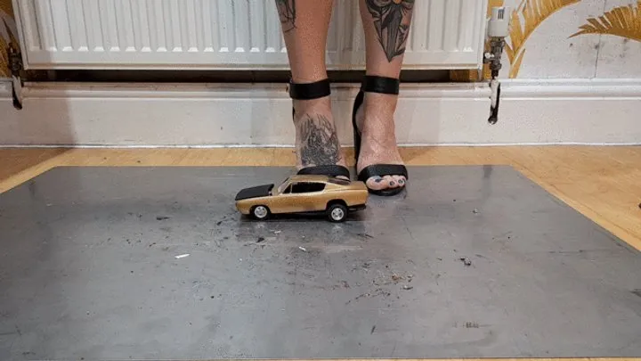 Giantess Atari queen destroys a Plymouth Barracud toy car crush in sexy black heels ground view