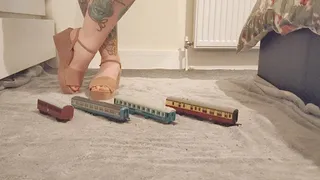 Giantess Jayne crushes tiny train carriages in pink wedges ground view