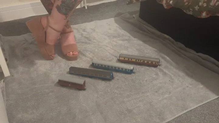 Giantess Jayne crushes tiny train carriages in pink wedges high view