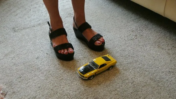 GIANTESS Charn crushes a yellow Ford Boss Mustang in black wedges closeup left view