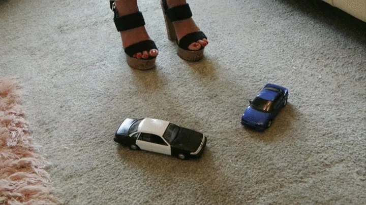 GIANTESS Charn crushes a Ford Crown Victoria police toy car & an old Toyota in chunky high heels close high right view