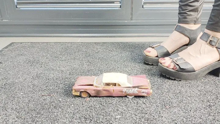 Abby Giantess toy car crush 1960s Cadillac Junker lower side view in sexy black platform high heels