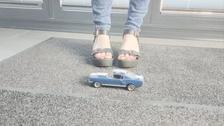 Ground view Abby Giantess crushing a 1966 Shelby Boss Mustang in black platform high heels