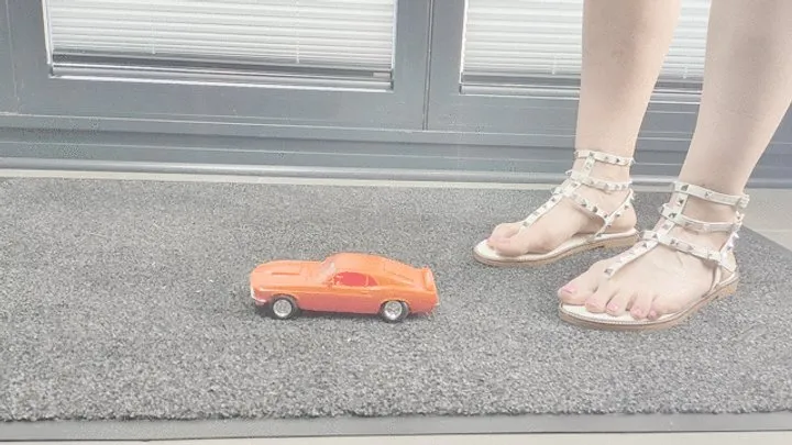 Abby Giantess toy car crush 1970 Boss Mustang in sexy flat sandals low side view