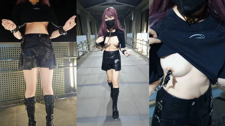 Handcuffs connected to nipple clamps outdoors