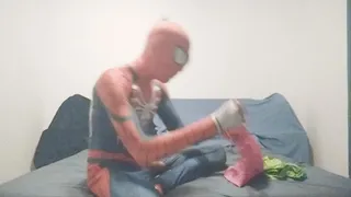 Spiderman is jerking while blowing up balloons