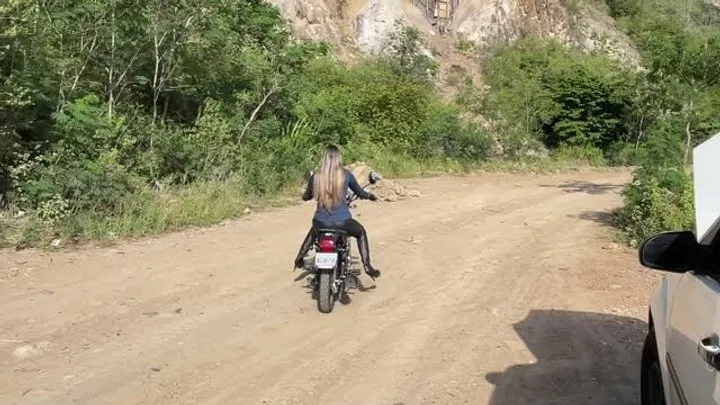 Jarlyn bounces on the seat of her motorcycle custom