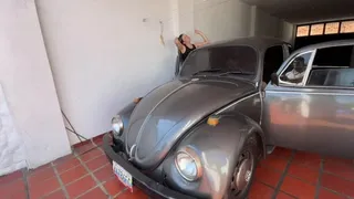 Girls in high wedge heels drive the VW beetle (Barbara driving)