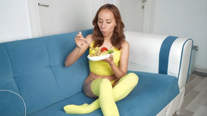 Pantera Nika in yellow lingerie eats her favorite food