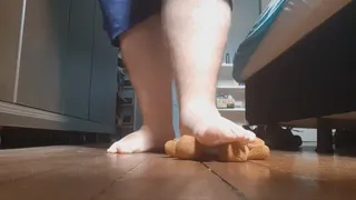 Giant feet crushing a teddy bear