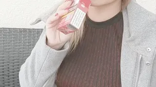 Smoking in a sexy dress, pantyhose and a coat
