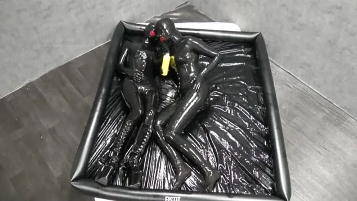 Rubber dolls cuddle in oily latex