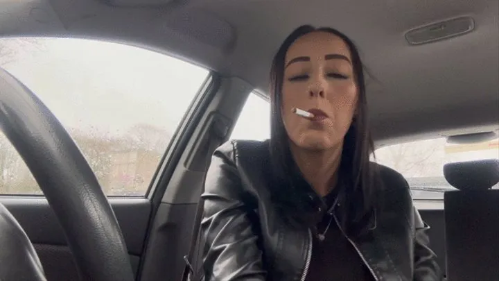 Smoking in car wearing leather gloves and jacket